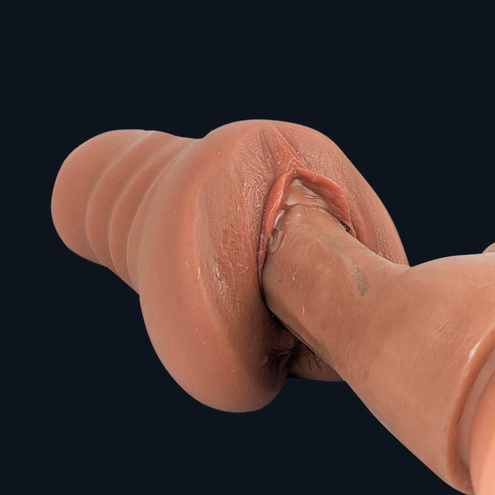 Close-up of a dildo in Emma's vaginal opening with lube